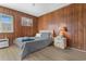 Bedroom featuring wood paneling, vinyl floors, ceiling fan, and Queen-sized bed with grey comforter at 191 Maison Dr. # B-319, Myrtle Beach, SC 29572