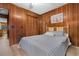 Bedroom with wood paneling, closet, and comfortable blue bedding at 191 Maison Dr. # B-319, Myrtle Beach, SC 29572