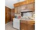 Kitchen featuring wood paneling, wood cabinets, white appliances, and vinyl floors at 191 Maison Dr. # B-319, Myrtle Beach, SC 29572