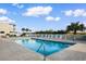 Community pool with white lounge chairs and fenced perimeter at 191 Maison Dr. # B-319, Myrtle Beach, SC 29572