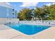 Community pool with lounge chairs and mature trees at 191 Maison Dr. # B-319, Myrtle Beach, SC 29572