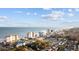 Stunning aerial view of the coastline with hotels, homes and white sandy beaches at 201-F Madison Ct., Myrtle Beach, SC 29577
