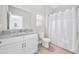 Bright bathroom featuring granite countertop vanity, toilet, and shower with curtain at 201-F Madison Ct., Myrtle Beach, SC 29577
