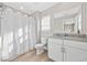 Bright bathroom featuring a shower with curtain, toilet, and sink with granite countertop at 201-F Madison Ct., Myrtle Beach, SC 29577