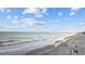 Relaxing beach scene with serene waters, soft sand, and people enjoying the coastal views at 201-F Madison Ct., Myrtle Beach, SC 29577