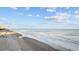 Beautiful beach with gentle waves, blue skies and fluffy clouds, perfect for a seaside escape at 201-F Madison Ct., Myrtle Beach, SC 29577