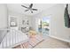 Bright bedroom features a comfortable daybed, ceiling fan, desk and sliding glass door to the outside at 201-F Madison Ct., Myrtle Beach, SC 29577