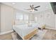 Comfortable bedroom featuring two beds, ceiling fan, and a cozy rug on light wood flooring at 201-F Madison Ct., Myrtle Beach, SC 29577