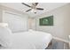Cozy bedroom boasts a comfortable bed, ceiling fan, and a modern TV for relaxing evenings at 201-F Madison Ct., Myrtle Beach, SC 29577