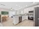 Open-concept kitchen with stainless steel appliances, white cabinets, and adjacent dining area at 201-F Madison Ct., Myrtle Beach, SC 29577