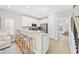 Modern kitchen with white cabinets, granite countertops, stainless steel appliances, and breakfast bar at 201-F Madison Ct., Myrtle Beach, SC 29577