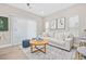 Cozy living room with a comfortable couch, stylish rug, and scenic paintings at 201-F Madison Ct., Myrtle Beach, SC 29577