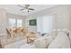 Bright living room with hardwood floors, neutral decor, and sliding glass doors at 201-F Madison Ct., Myrtle Beach, SC 29577