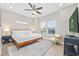 Bright bedroom with a large window, ceiling fan, and cozy decor at 201-F Madison Ct., Myrtle Beach, SC 29577