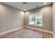 This is a bedroom featuring wood floors and a large window for natural light at 204 Shady Pines Ct., Conway, SC 29527