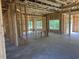 Unfinished new construction shows the framework of a home with stud walls and concrete flooring at 204 Shady Pines Ct., Conway, SC 29527