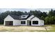 Beautiful exterior of newly constructed white home with dark trim and a garage at 204 Shady Pines Ct., Conway, SC 29527