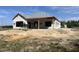 New home construction shows the initial framing stage, the roof with protective covering, and prepped yard at 204 Shady Pines Ct., Conway, SC 29527