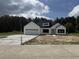 Charming new construction with white siding, black trim, and a spacious driveway at 204 Shady Pines Ct., Conway, SC 29527