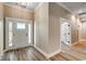 Bright foyer with light wood flooring and a front door with sidelights and a transom window at 204 Shady Pines Ct., Conway, SC 29527