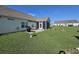 Spacious backyard with a screen room, grill, and a well-maintained lawn at 213 Cupola Dr., Longs, SC 29568