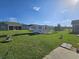 Landscaped backyard featuring a shed, mature trees, statues, and lawn at 213 Cupola Dr., Longs, SC 29568