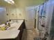Standard bathroom featuring double sinks, large vanity mirror and shower with curtain at 213 Cupola Dr., Longs, SC 29568