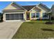 Charming single-story home featuring a screened garage, manicured lawn and welcoming curb appeal at 213 Cupola Dr., Longs, SC 29568