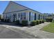 Charming building exterior with white siding, black shutters, and ample windows for natural light at 213 Cupola Dr., Longs, SC 29568