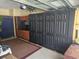 View of garage interior featuring workspace, cabinets, storage and door at 213 Cupola Dr., Longs, SC 29568