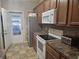 Bright kitchen featuring tile flooring, stainless appliances and a door with light at 213 Cupola Dr., Longs, SC 29568