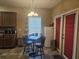 Eat-in kitchen area with a table and chairs, and a view of the red door at 213 Cupola Dr., Longs, SC 29568