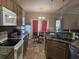 Well-lit eat-in kitchen with bar seating and stainless steel appliances at 213 Cupola Dr., Longs, SC 29568