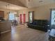 Open-concept living area featuring wood floors, comfortable seating, and adjacent dining space at 213 Cupola Dr., Longs, SC 29568