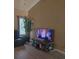 Comfortable living room with entertainment center and large window with mini blinds at 213 Cupola Dr., Longs, SC 29568