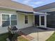 A backyard patio with a retractable awning, barbeque grill and patio furniture at 213 Cupola Dr., Longs, SC 29568