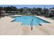 Large community swimming pool with clear blue water and lounge chairs under a bright, sunny sky at 213 Cupola Dr., Longs, SC 29568
