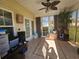 Bright sunroom featuring tile floors, neutral walls, large windows and a ceiling fan at 213 Cupola Dr., Longs, SC 29568