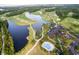 Aerial view of the golf course, clubhouse, pool, and lake in Grande Dunes, Myrtle Beach, SC at 2151 Bridgeview Ct. # 3-305, North Myrtle Beach, SC 29582