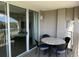 Condo balcony with table and chairs adjacent to sliding glass doors at Grande Dunes, Myrtle Beach, SC at 2151 Bridgeview Ct. # 3-305, North Myrtle Beach, SC 29582