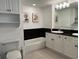 Bright bathroom featuring a tub, granite countertops, vanity with storage, and decorative artwork at 2151 Bridgeview Ct. # 3-305, North Myrtle Beach, SC 29582