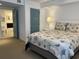 Cozy bedroom featuring a queen bed with seashell themed bedding and an ensuite bathroom at 2151 Bridgeview Ct. # 3-305, North Myrtle Beach, SC 29582