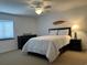 Well-lit bedroom with a queen bed, ceiling fan, dresser, and surf themed decor at 2151 Bridgeview Ct. # 3-305, North Myrtle Beach, SC 29582