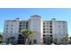 Exterior building view with Mediterranean-style architecture, balconies, and palm trees at Grande Dunes in Myrtle Beach, SC at 2151 Bridgeview Ct. # 3-305, North Myrtle Beach, SC 29582