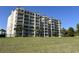 Exterior side view of the Mediterranean-style condo building with multiple balconies and a grassy lawn area at 2151 Bridgeview Ct. # 3-305, North Myrtle Beach, SC 29582