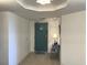 Hallway featuring a small table with a lamp, blue door, and tile flooring at 2151 Bridgeview Ct. # 3-305, North Myrtle Beach, SC 29582
