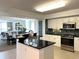 Open kitchen with granite counters, tile backsplash, and stainless appliances that leads to the dining and living area at 2151 Bridgeview Ct. # 3-305, North Myrtle Beach, SC 29582