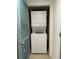 A laundry closet features a stacked washer and dryer set, enhancing convenience in this space at 2151 Bridgeview Ct. # 3-305, North Myrtle Beach, SC 29582