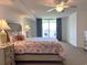 Cozy main bedroom with a ceiling fan and private balcony offers a relaxing retreat at 2151 Bridgeview Ct. # 3-305, North Myrtle Beach, SC 29582