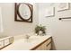 Charming bathroom featuring a decorative mirror, vanity, and coastal-themed décor, perfect for relaxation at 220 Clubhouse Dr. # 20B, Sunset Beach, NC 28468